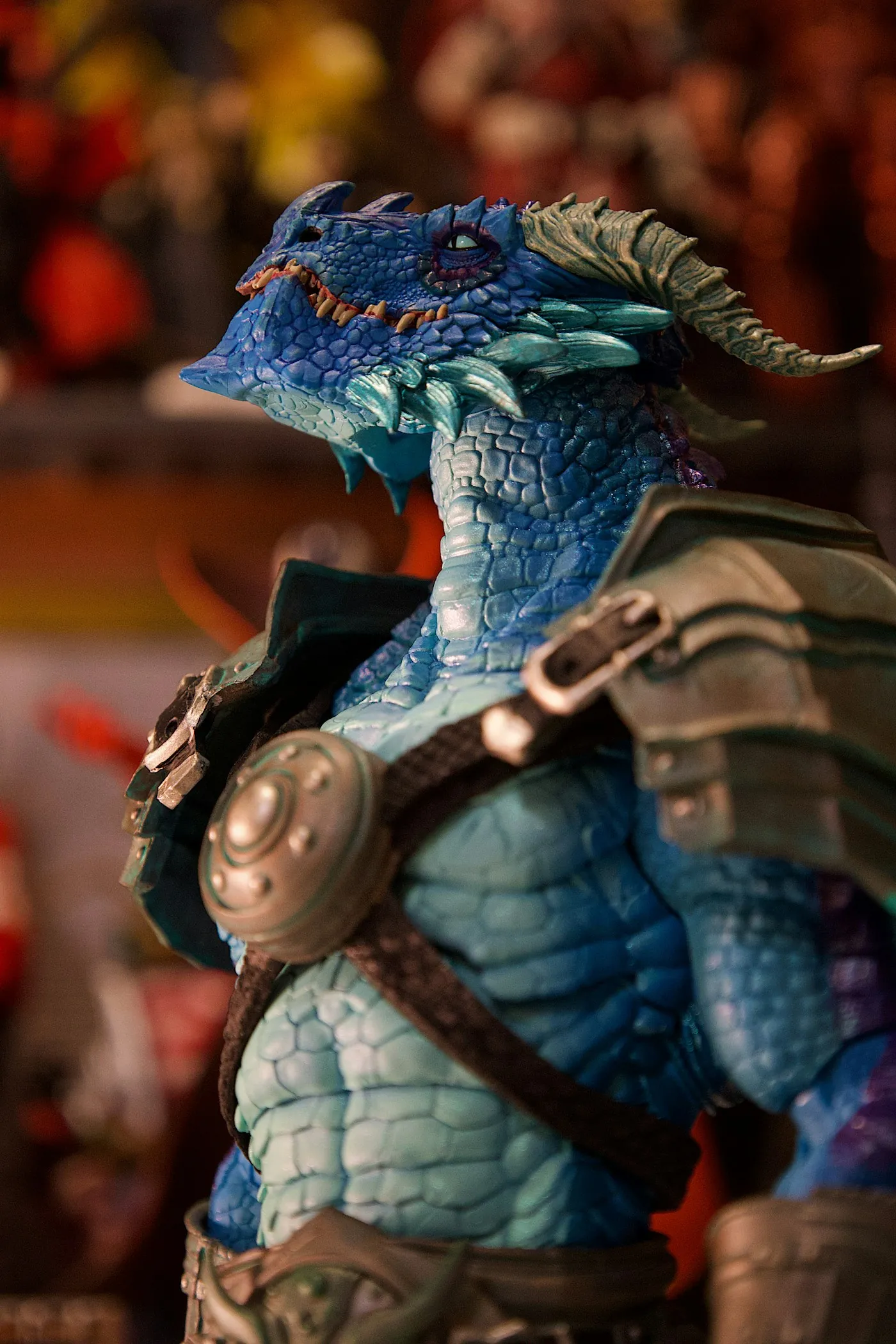 Hand-painted blue dragon-folk bust with layered scale highlights and weathered armor.